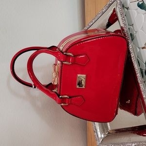 Adorable red patent purse with a pave rhinstone bow closure!